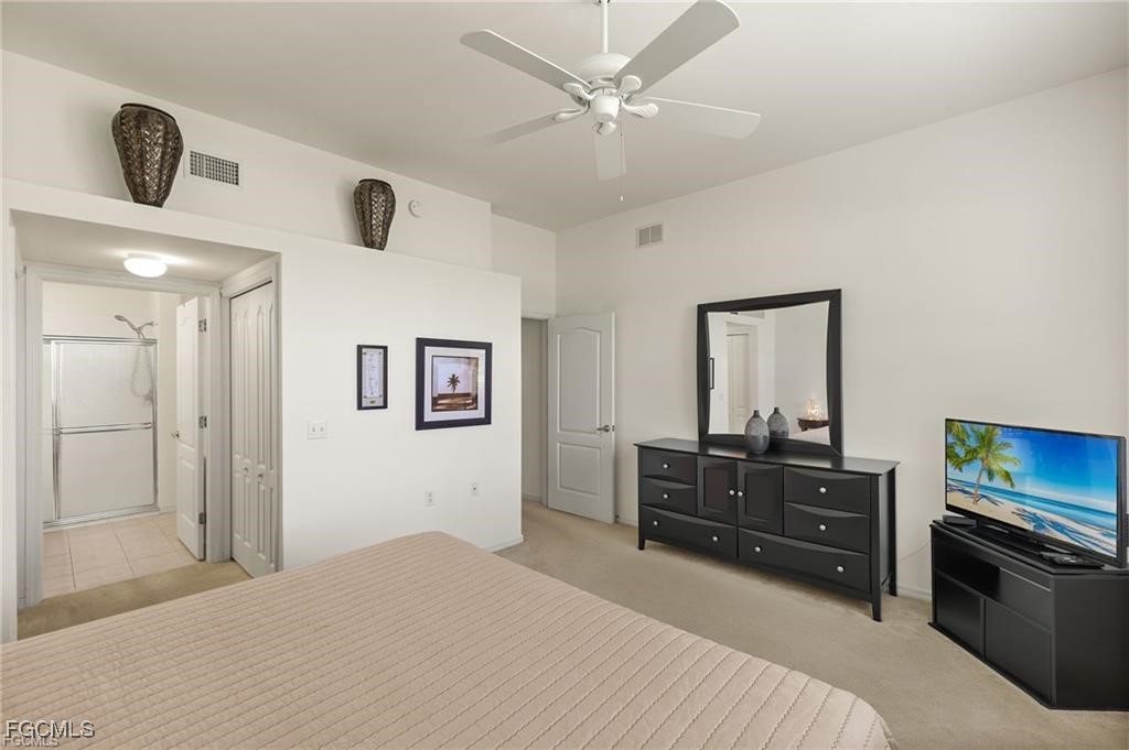 12120 Summergate Circle, Unit 103 Fort Myers, FL 33913 - Photo 12 of 26 a bedroom with a bed and a television