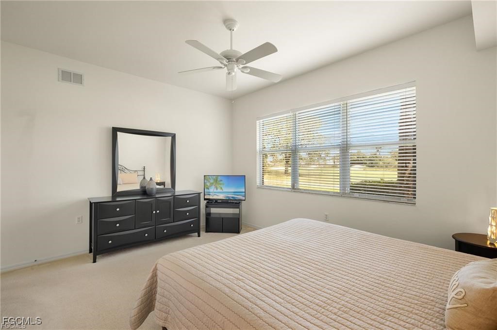 12120 Summergate Circle, Unit 103 Fort Myers, FL 33913 - Photo 13 of 26 a bedroom with a bed dresser and a window
