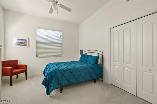 a living room with a bed and a chair