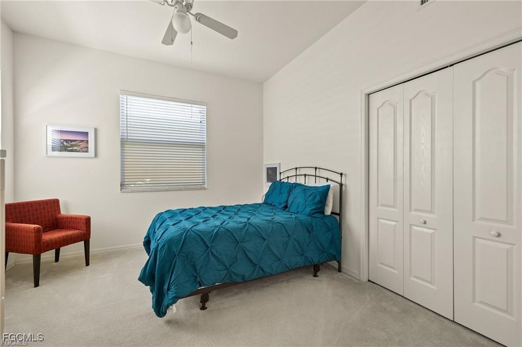 12120 Summergate Circle, Unit 103 Fort Myers, FL 33913 - Photo 15 of 26 a living room with a bed and a chair