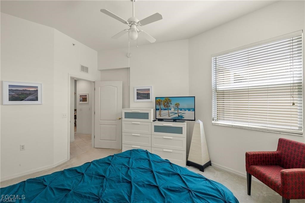 12120 Summergate Circle, Unit 103 Fort Myers, FL 33913 - Photo 16 of 26 a bedroom with a bed and a couch