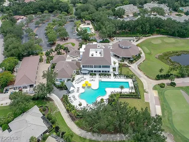 an aerial view of a house with a swimming pool outdoor seating and yard