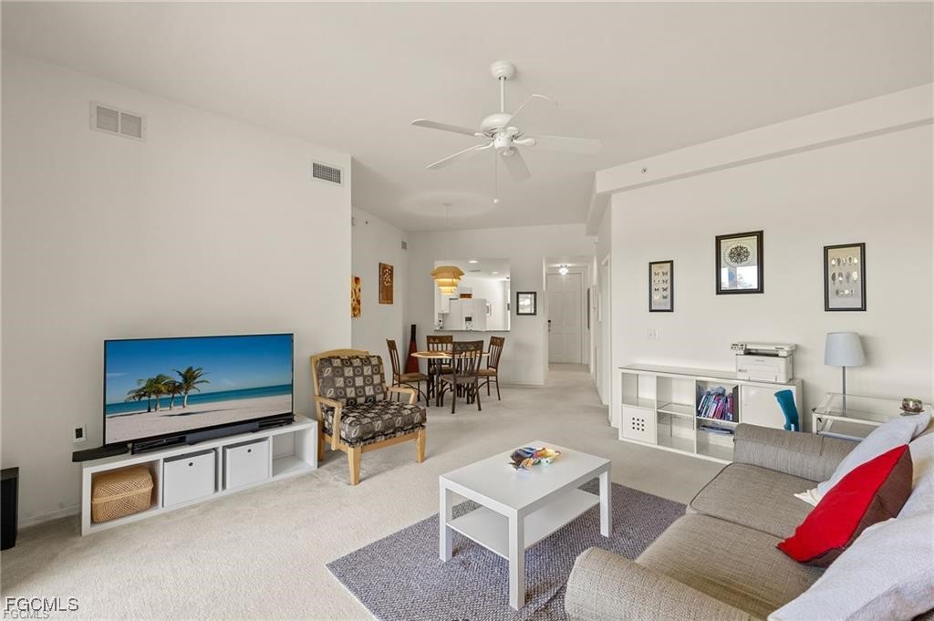 12120 Summergate Circle, Unit 103 Fort Myers, FL 33913 - Photo 3 of 26 a living room with furniture and a flat screen tv