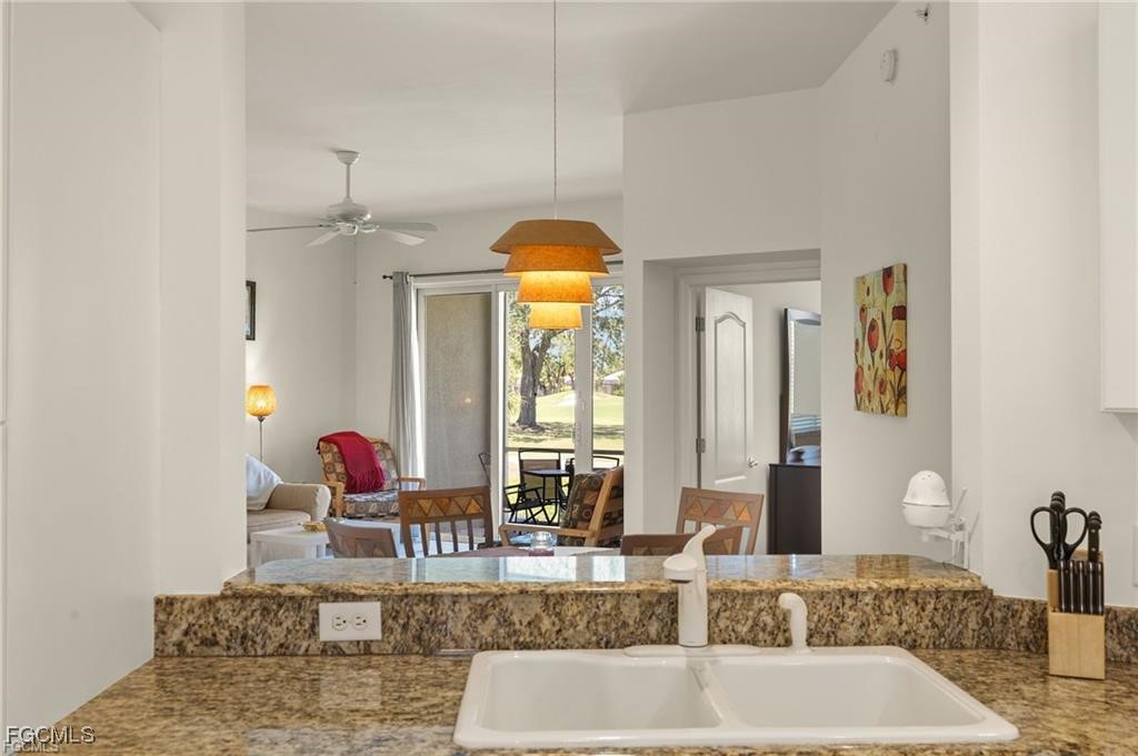 12120 Summergate Circle, Unit 103 Fort Myers, FL 33913 - Photo 6 of 26 a bathroom with a granite countertop sink and a mirror