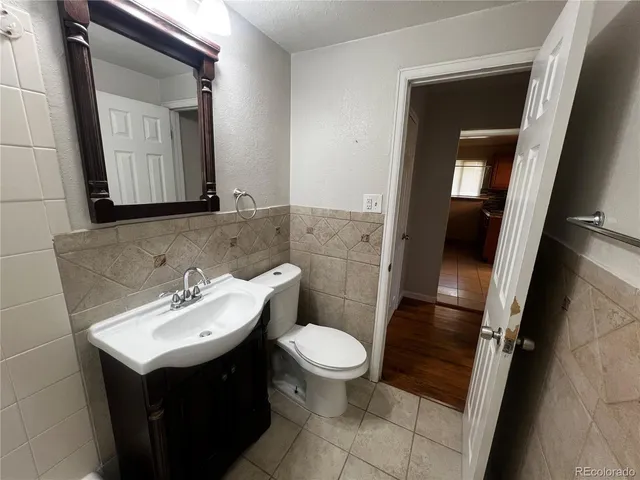 a bathroom with a sink toilet and mirror
