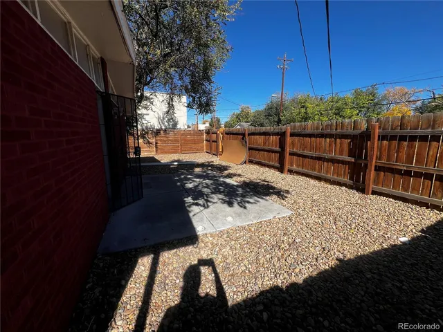 a view of a backyard with wooden fence