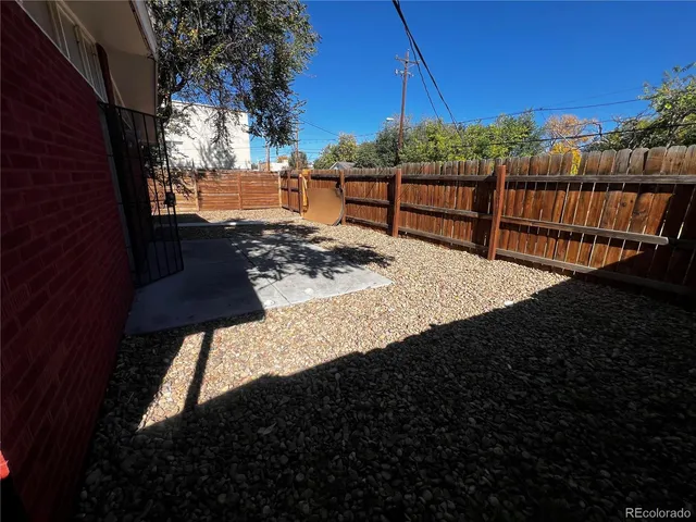 a view of a backyard with sitting area
