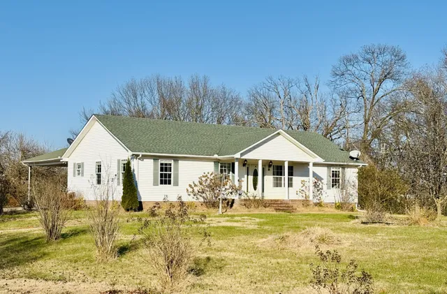 a front view of a house with a yard table and chairs