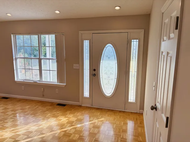 a view of a livingroom with wooden floor and a window