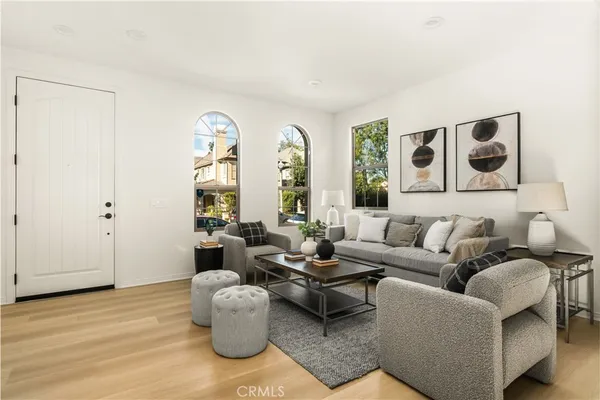 a living room with furniture and a potted plant