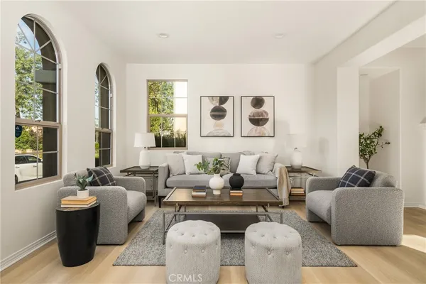 a living room with furniture and floor to ceiling windows