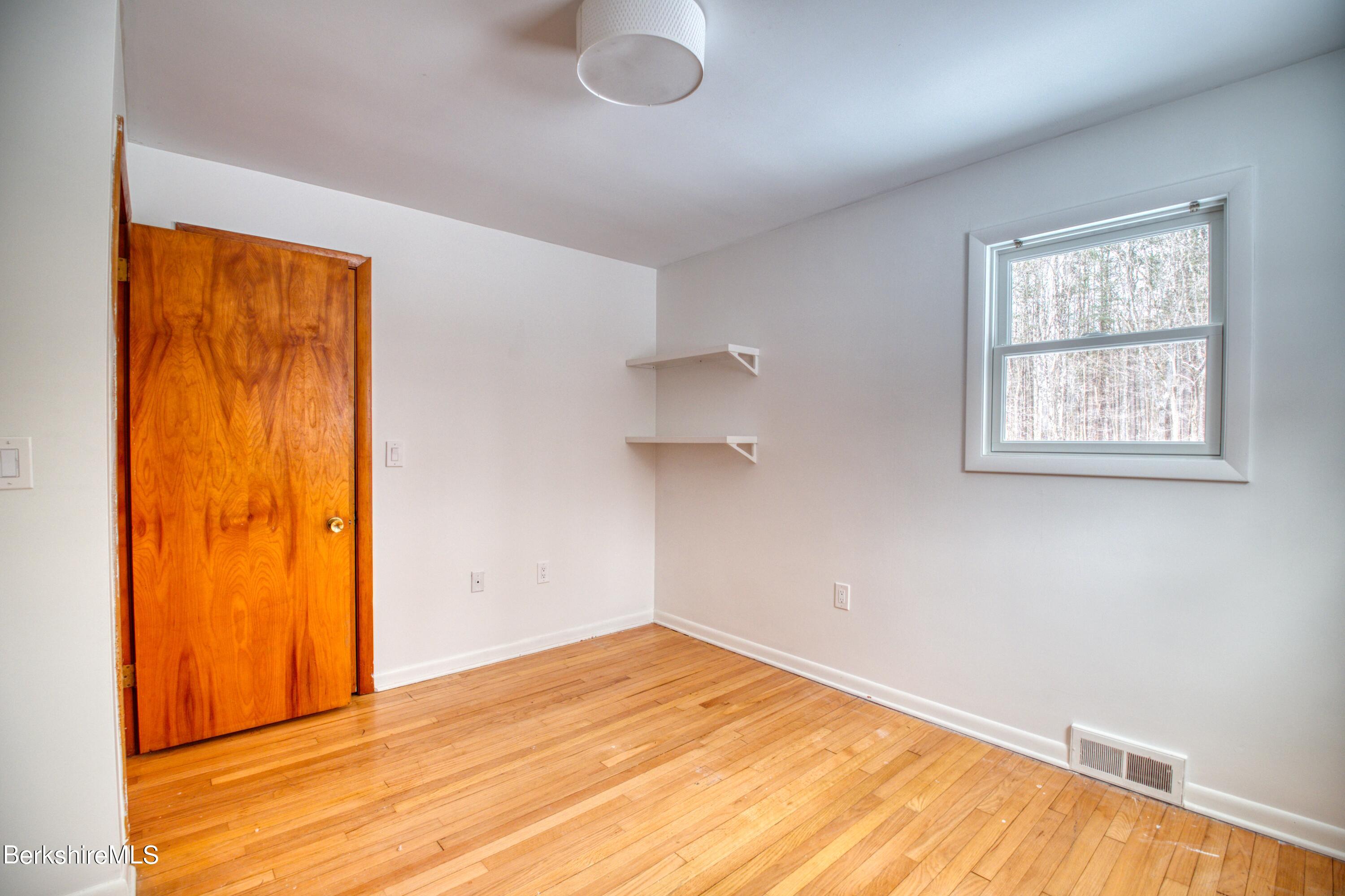 2500 State Road Richmond, MA 01254 - Photo 14 of 35 wooden floor in an empty room with a window