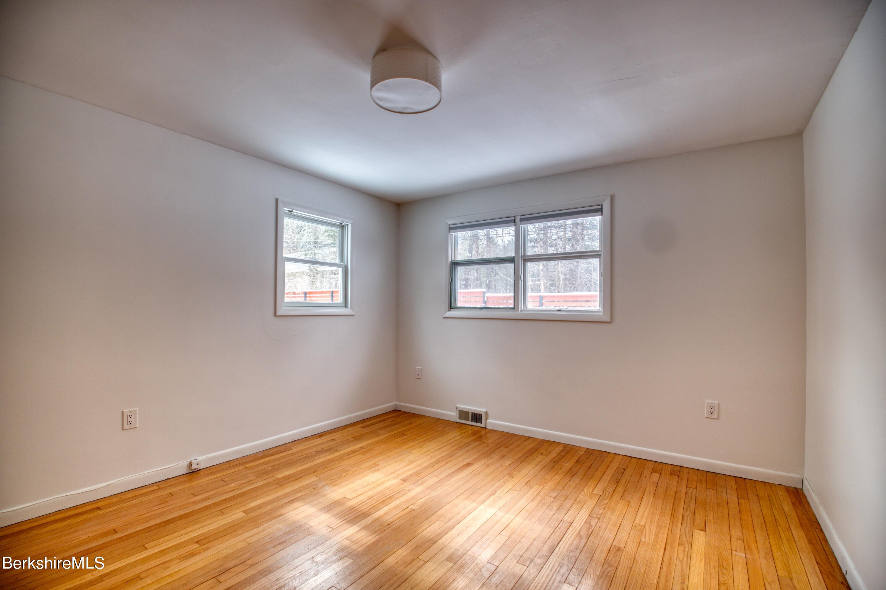 2500 State Road Richmond, MA 01254 - Photo 15 of 35 a view of empty room with wooden floor and fan