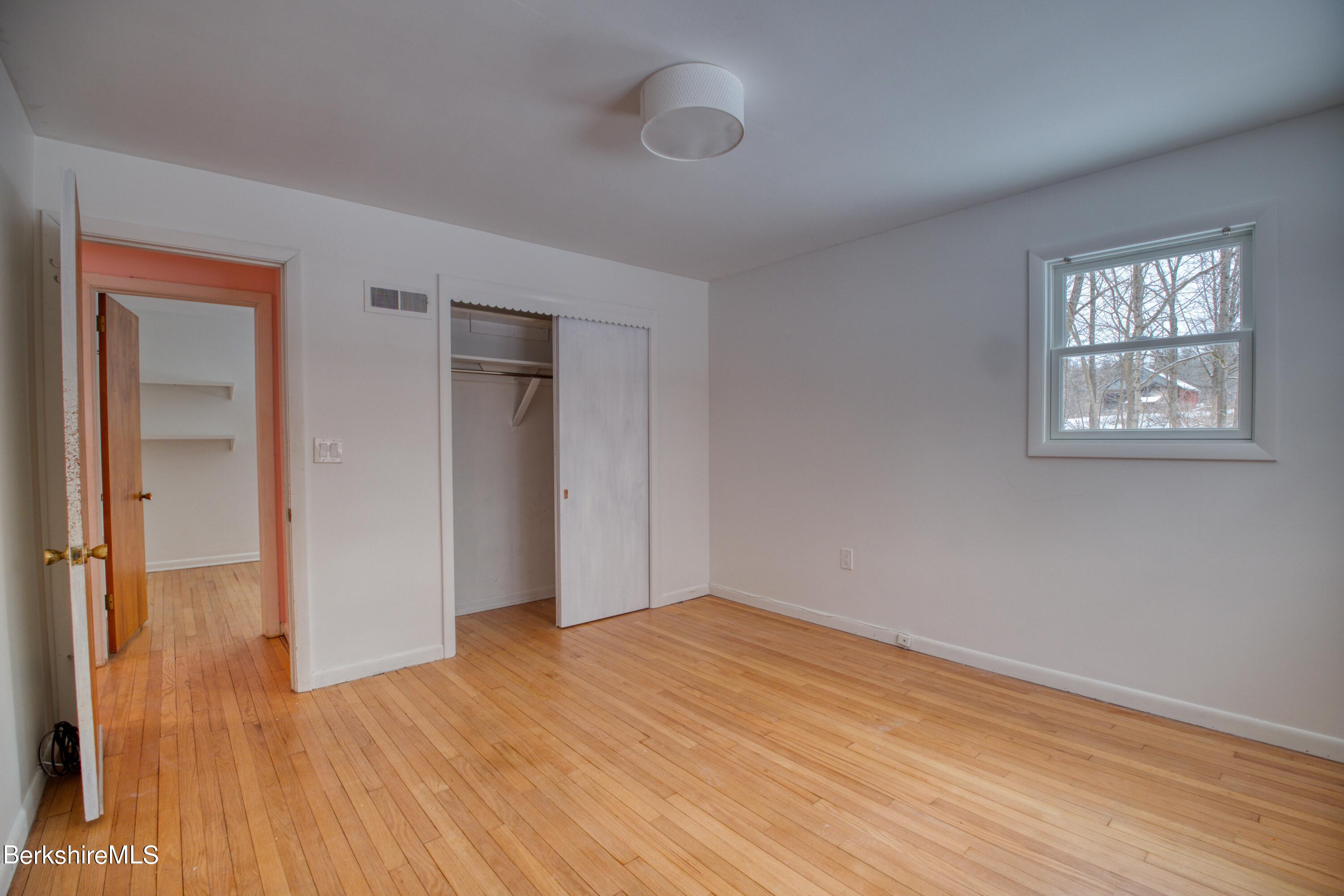 2500 State Road Richmond, MA 01254 - Photo 16 of 35 a view of empty room with wooden floor and fan