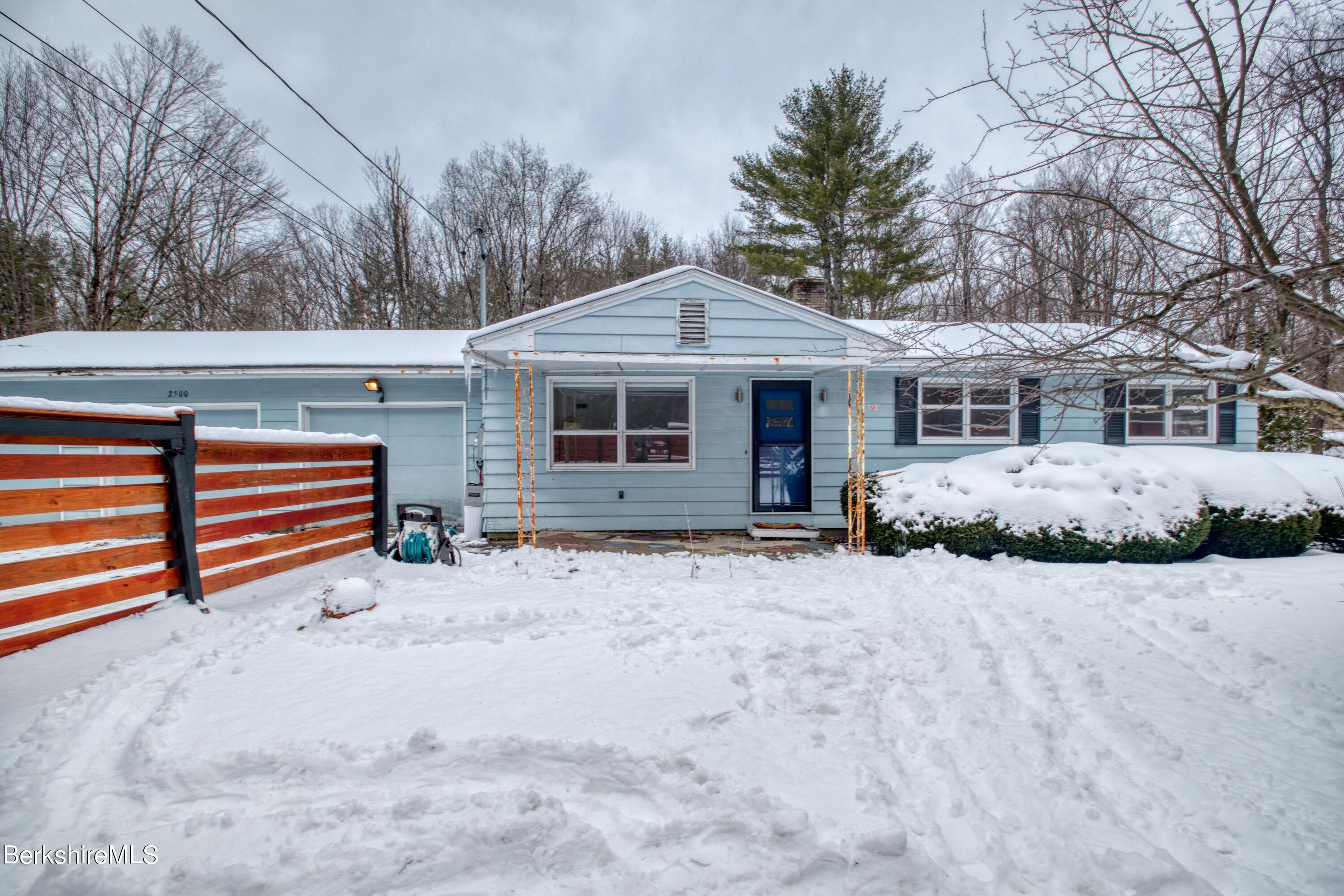 2500 State Road Richmond, MA 01254 - Photo 2 of 35 a front view of a house with a yard covered in snow