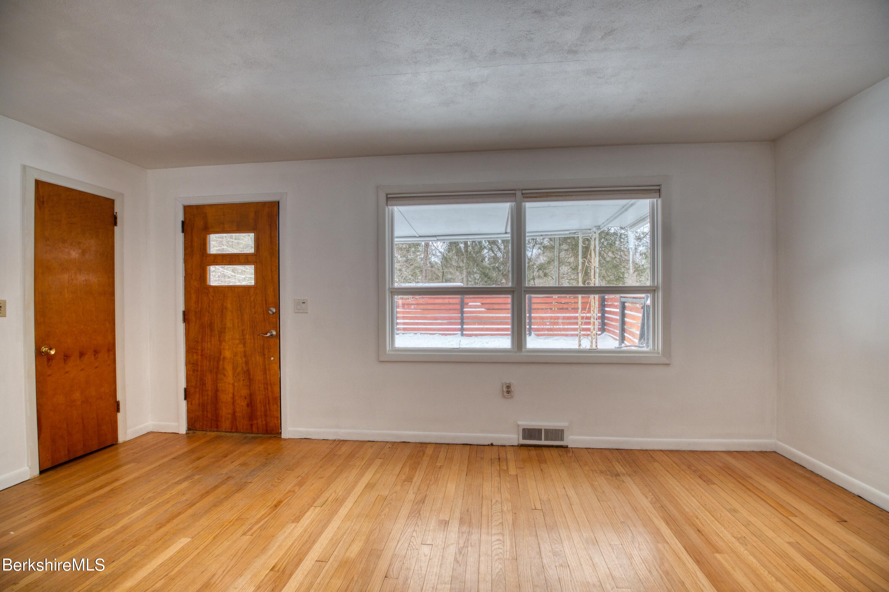 2500 State Road Richmond, MA 01254 - Photo 3 of 35 an empty room with wooden floor and windows
