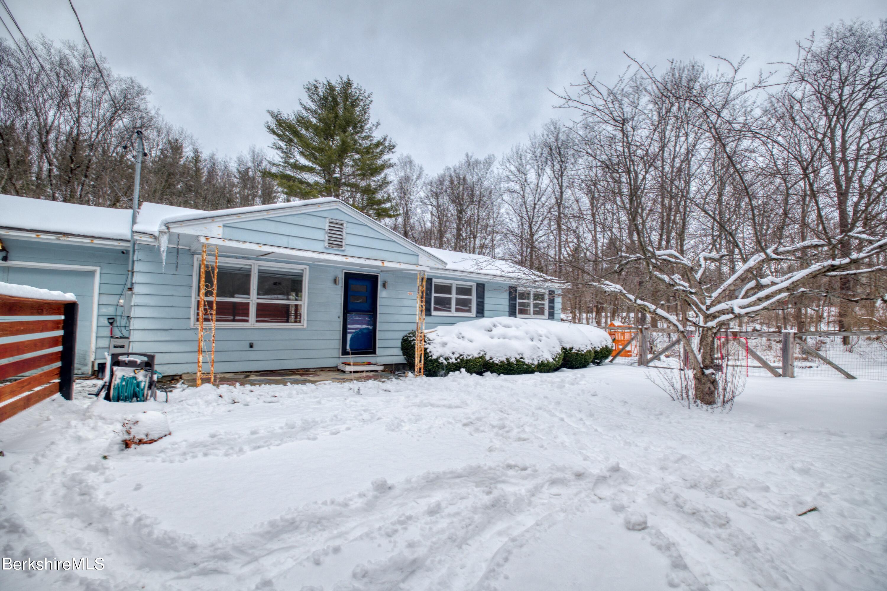 2500 State Road Richmond, MA 01254 - Photo 33 of 35 a front view of a house with a yard covered in snow