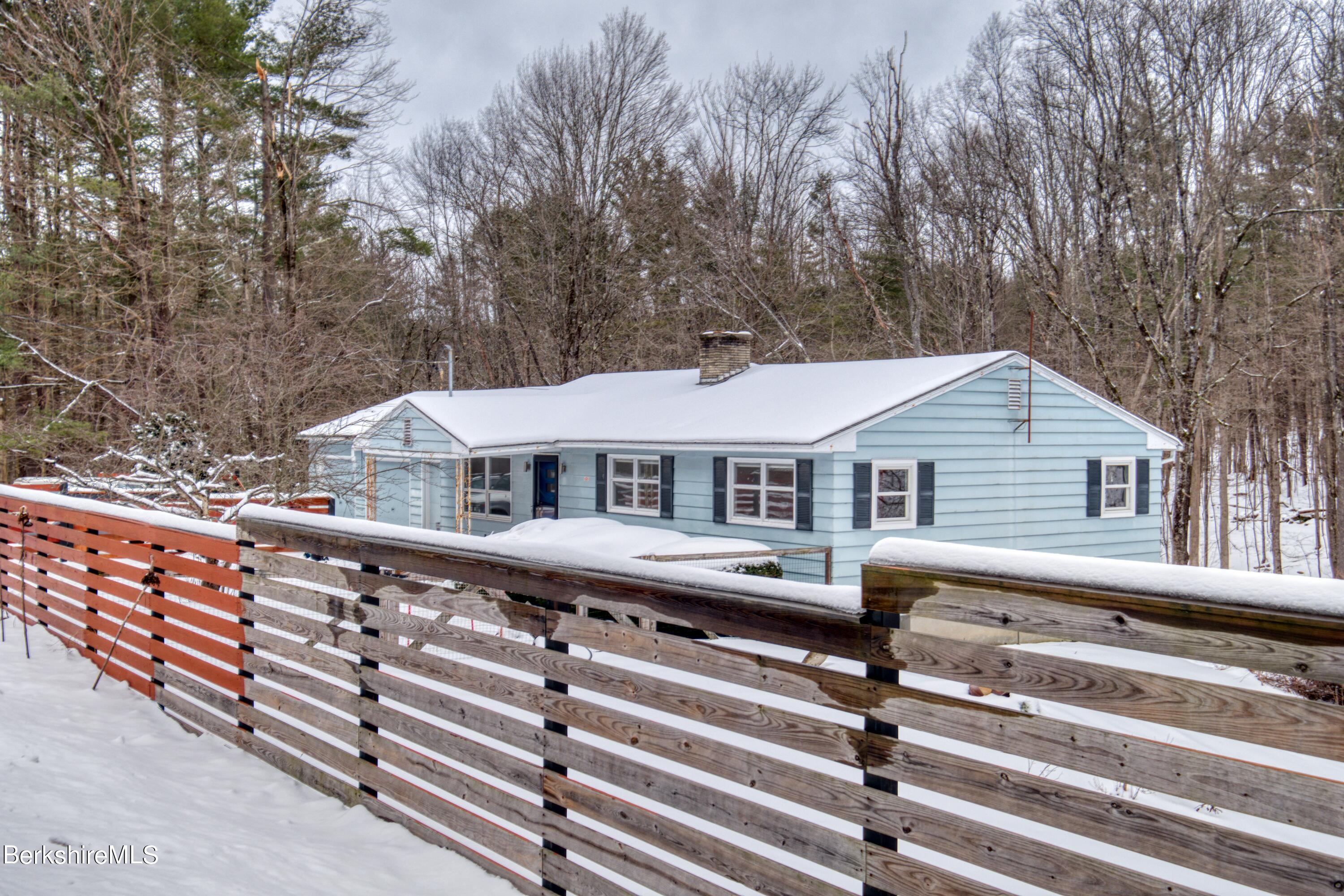 2500 State Road Richmond, MA 01254 - Photo 35 of 35 a roof deck with a table and chairs under an umbrella