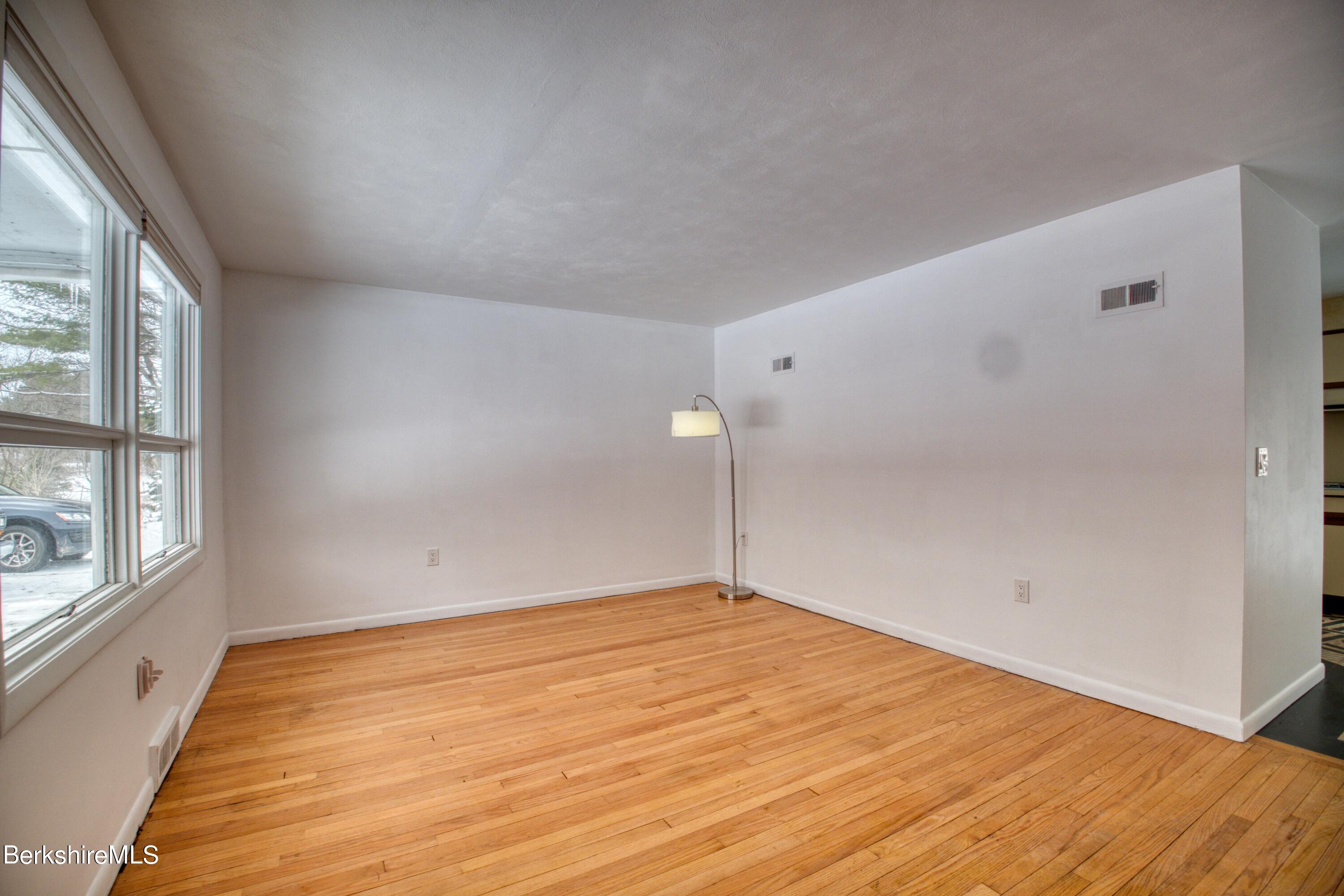2500 State Road Richmond, MA 01254 - Photo 5 of 35 a view of an empty room with wooden floor and windows