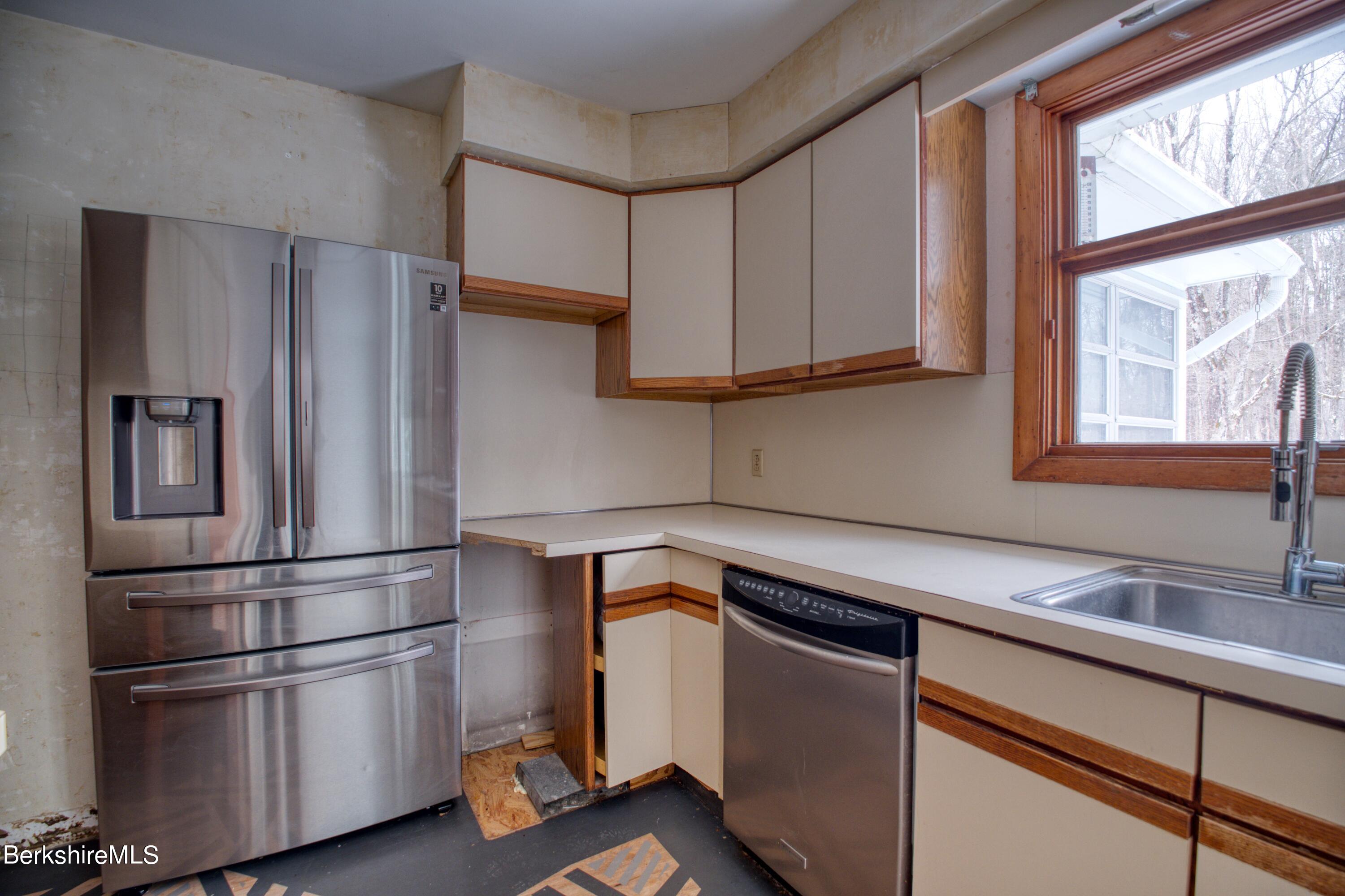 2500 State Road Richmond, MA 01254 - Photo 8 of 35 a kitchen with stainless steel appliances a refrigerator and a sink