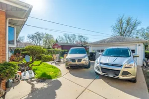 a view of a chair and table in backyard of the house