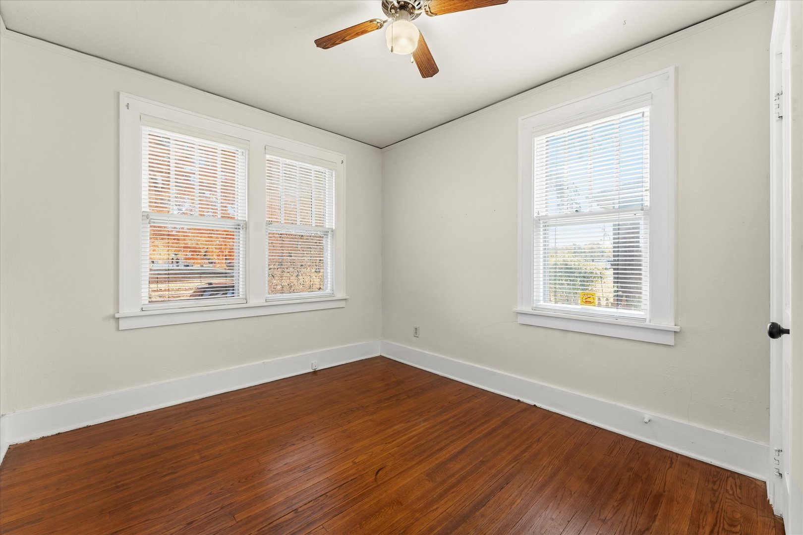 707 South Pine Street Champaign, IL 61820 - Photo 18 of 32 a view of an empty room with wooden floor and a window