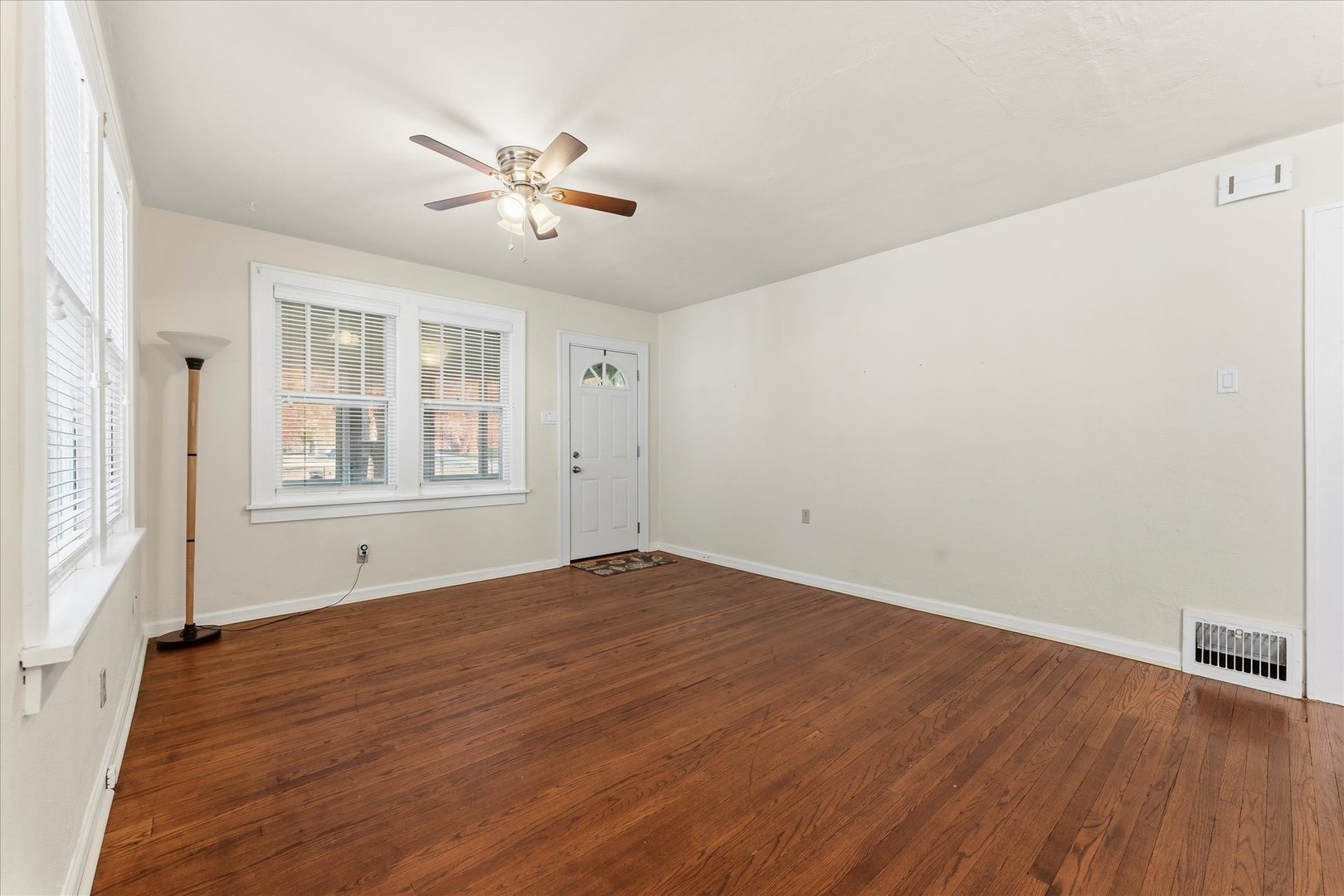 707 South Pine Street Champaign, IL 61820 - Photo 9 of 32 a view of an empty room with window and wooden floor