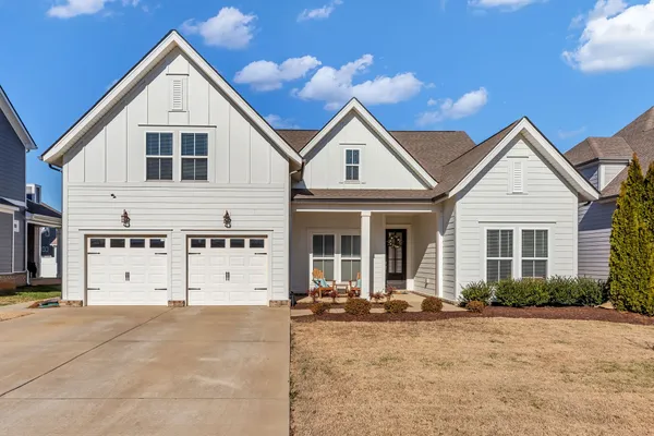 a view of a house with a yard and garage