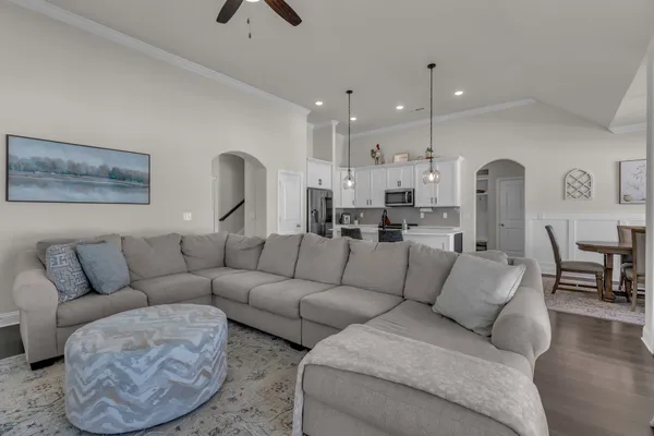 a living room with furniture and a chandelier