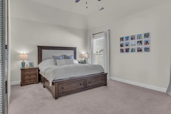 a bed sitting in a bedroom and lamp