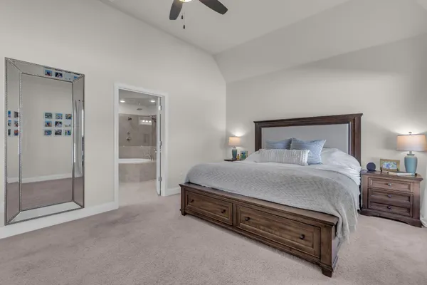 a spacious bedroom with a bed and a shower