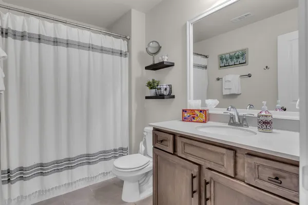 a spacious bedroom with a bed and a ceiling fan