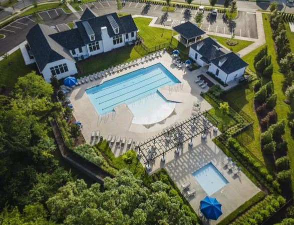 a view of a swimming pool with a patio and a yard