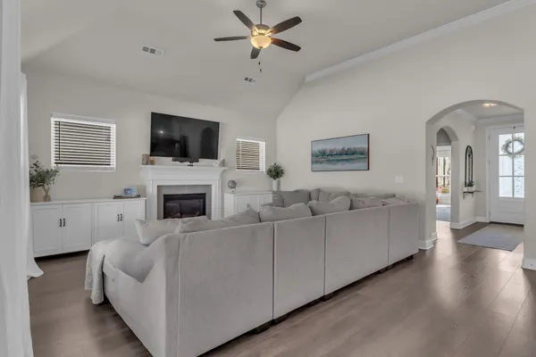 a living room with furniture a flat screen tv and a fireplace