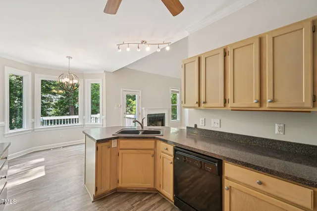 a kitchen with stainless steel appliances granite countertop a sink a stove and cabinets