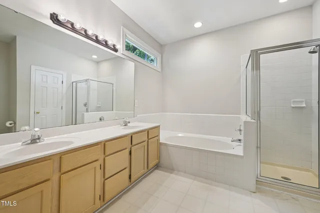 a bathroom with a double vanity sink mirror double and shower