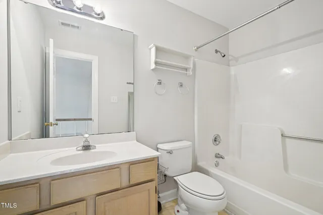 a bathroom with a sink toilet vanity and shower