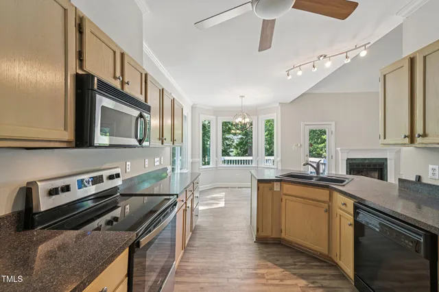 a kitchen with stainless steel appliances granite countertop a sink and stove top oven