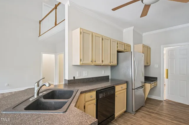 a kitchen with stainless steel appliances granite countertop a sink a refrigerator and a granite counter tops