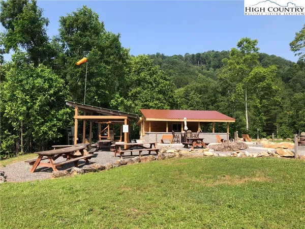 a view of backyard with wooden deck and outdoor seating