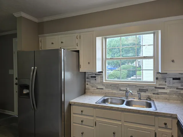 a kitchen with a refrigerator and a sink