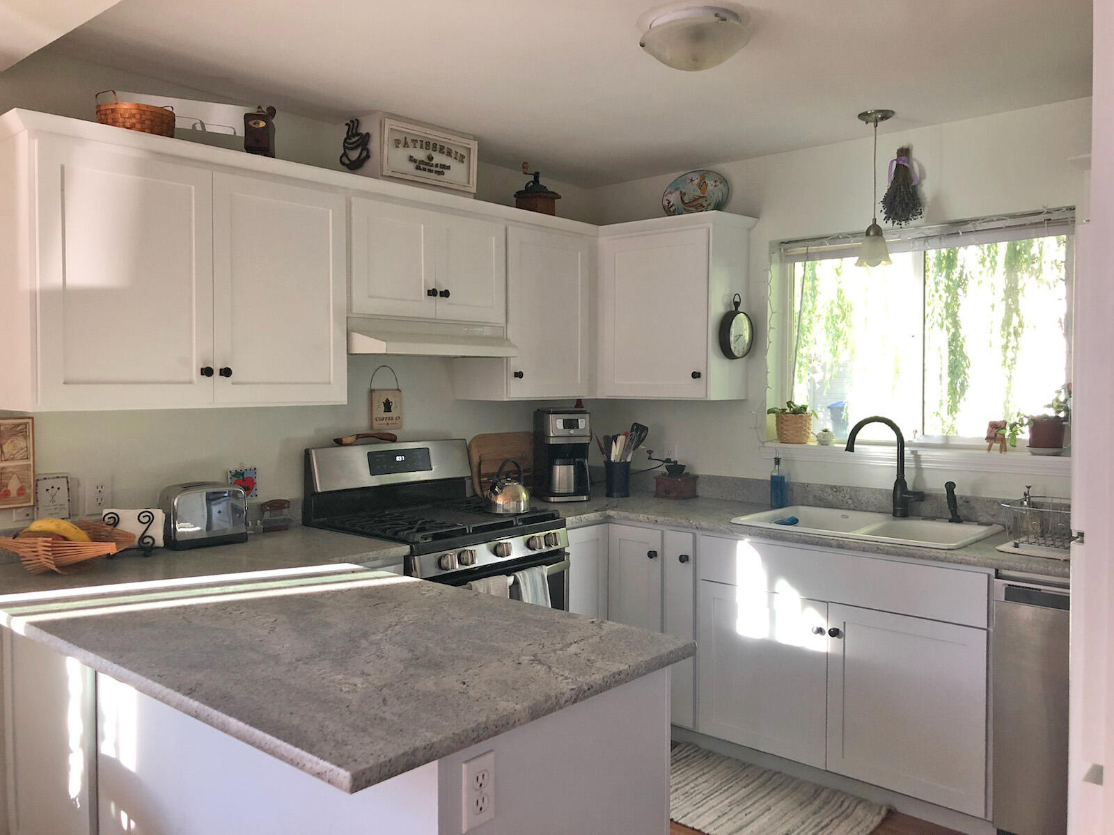 1399 Mill Pond Road Ashland, OR 97520 - Photo 11 of 28 a kitchen with granite countertop a sink a stove and cabinets