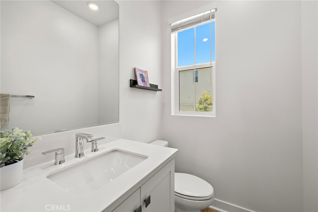 61 Wheelbarrow Road Rancho Mission Viejo, CA 92694 - Photo 27 of 74 a bathroom with a toilet a sink and mirror