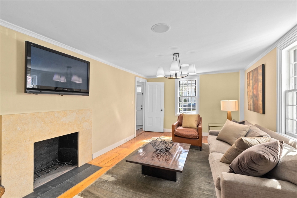132 Main Street Hingham, MA 02043 - Photo 15 of 42 a living room with furniture a fireplace and a flat screen tv