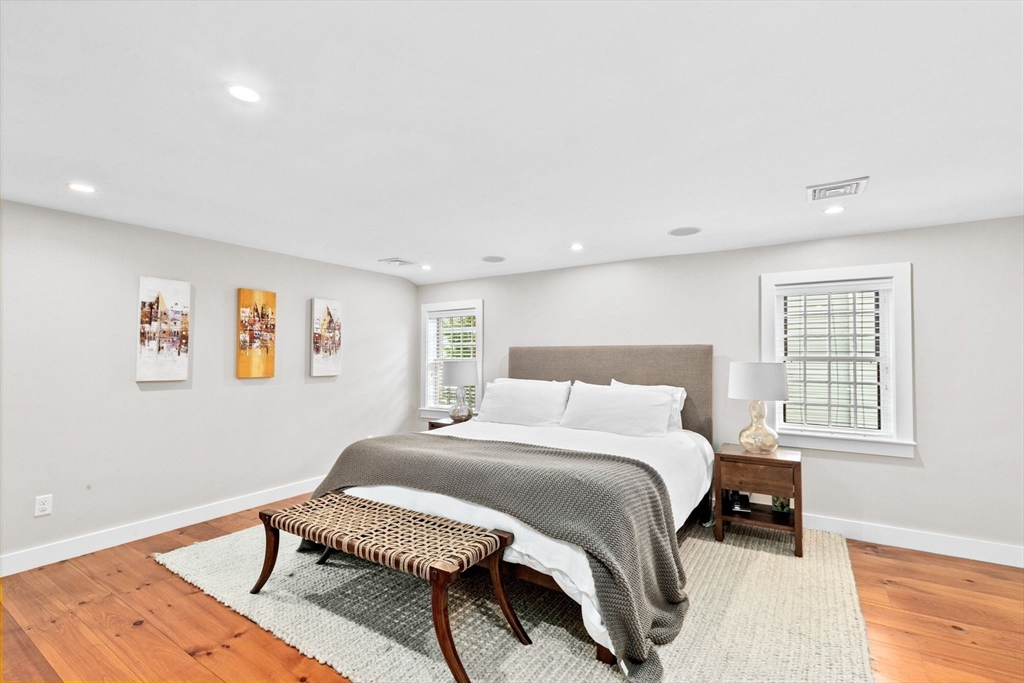 132 Main Street Hingham, MA 02043 - Photo 20 of 42 a bedroom with a bed and wooden floor