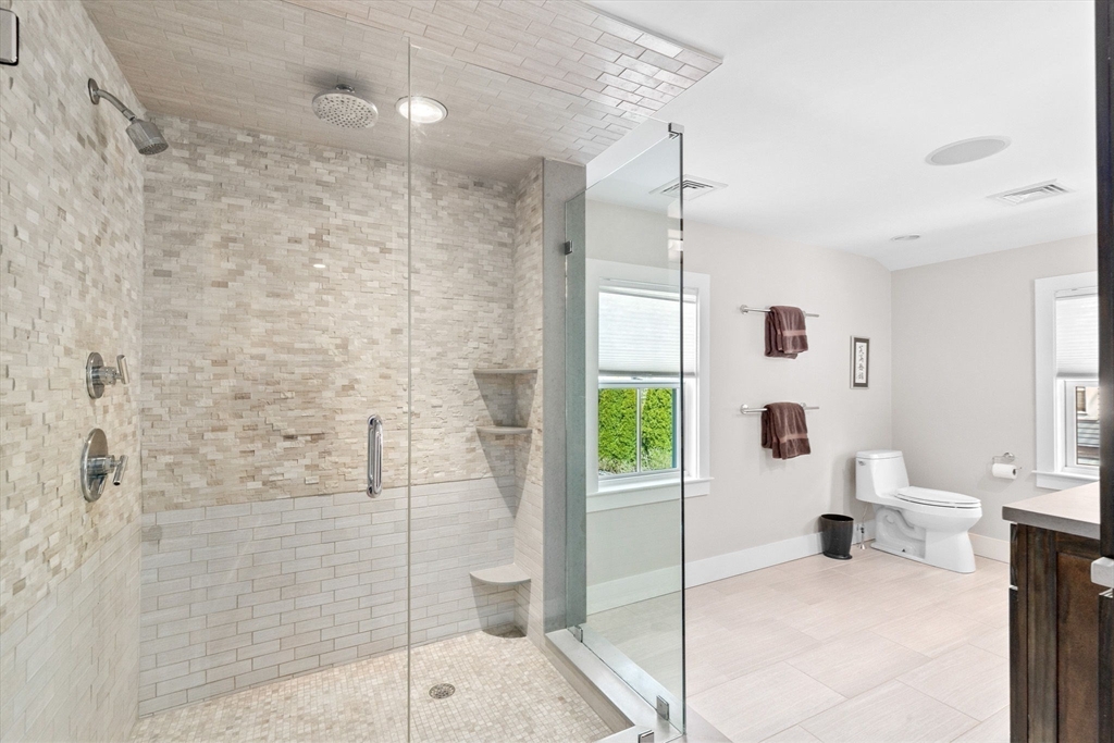 132 Main Street Hingham, MA 02043 - Photo 23 of 42 a bathroom with a tub shower and mirror