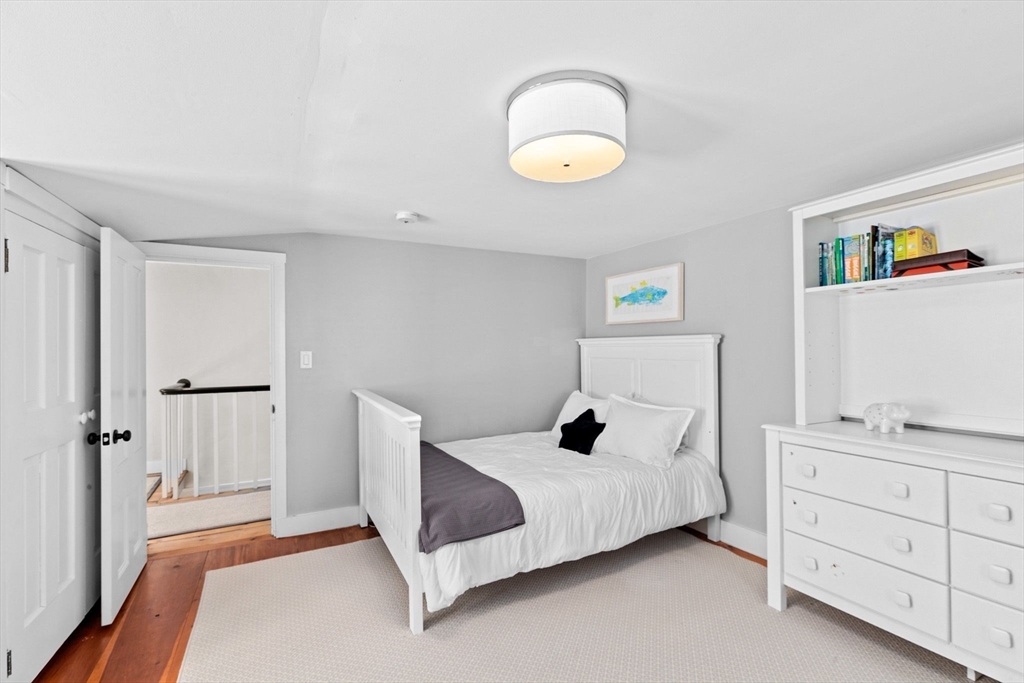 132 Main Street Hingham, MA 02043 - Photo 24 of 42 a bedroom with a bed and a cabinets