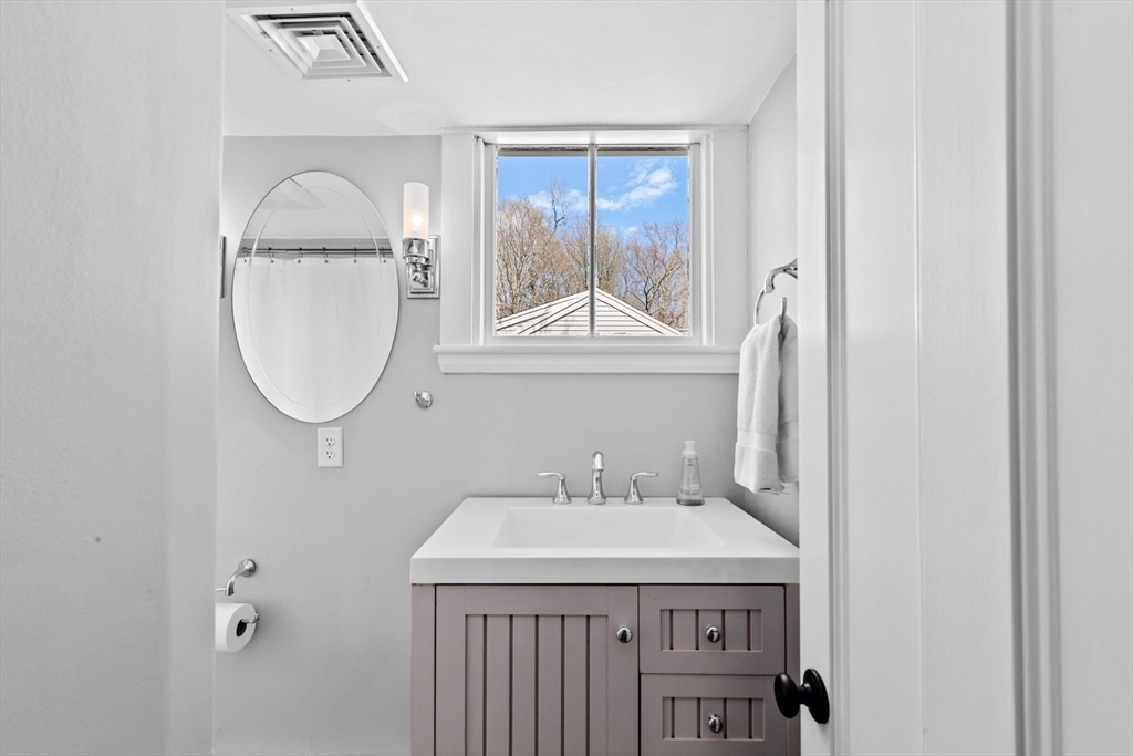 132 Main Street Hingham, MA 02043 - Photo 28 of 42 a bathroom with a sink a mirror and a vanity