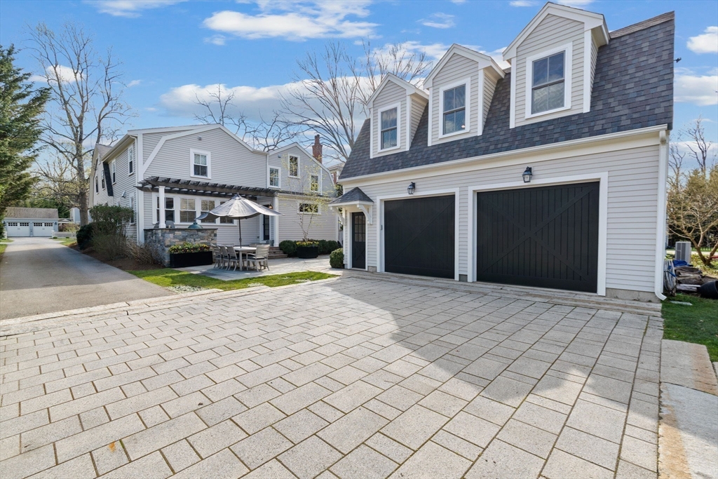 132 Main Street Hingham, MA 02043 - Photo 29 of 42 a view of a white house with a yard and potted plants