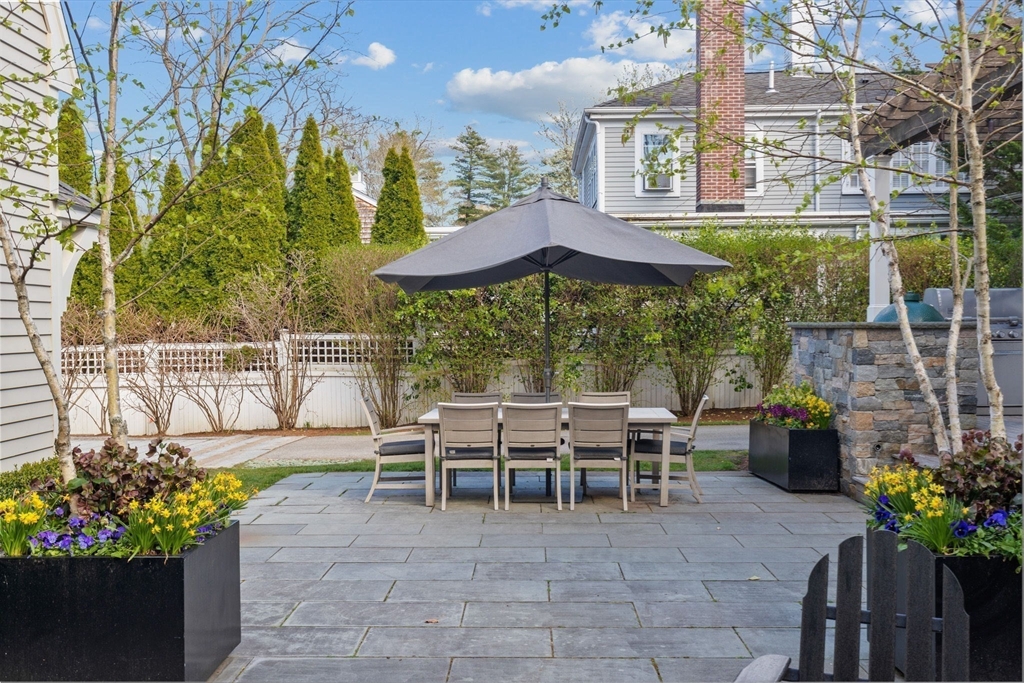 132 Main Street Hingham, MA 02043 - Photo 32 of 42 a view of a chairs and table in the backyard